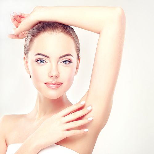 Armpit epilation, lacer hair removal. Young woman holding her ar